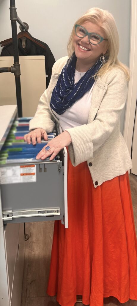 a woman opening a file cabinet in coworking space in Hyannis